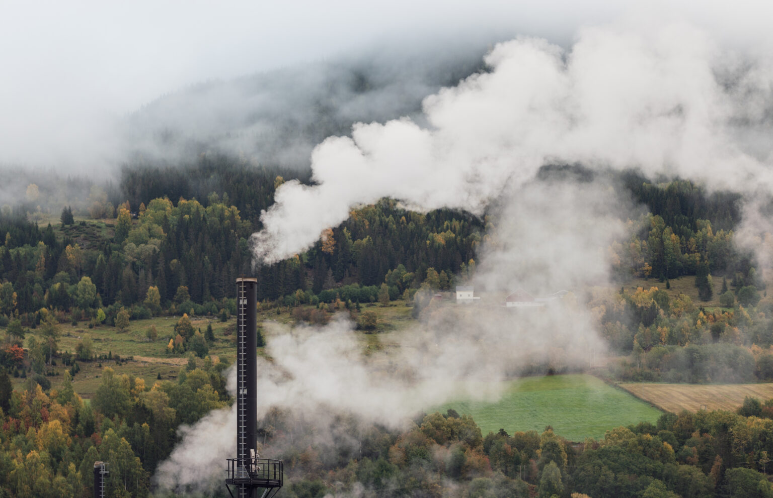 Industrial emissions from factory chimney representing ClimatePath emissions assessment and climate action planning